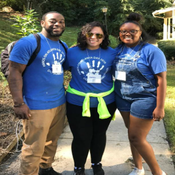 black man and 2 black women smiling